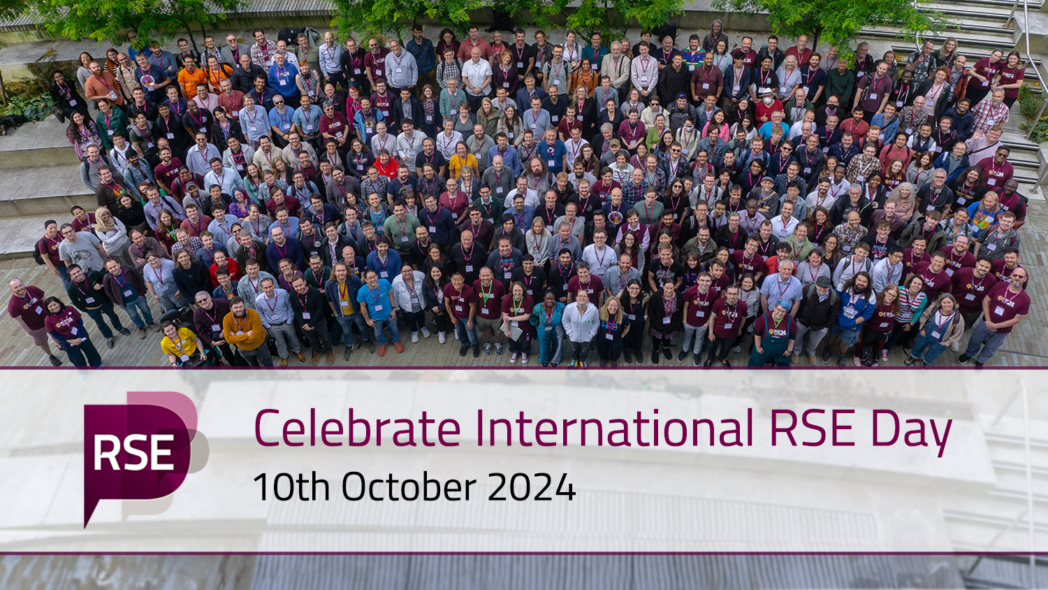 A photo of the attendees at RSECon24 - a few hundred people standing on stone steps, looking up at the camera. The images is overlayed with a white banner, which includes the RSE Society Logo and two rows of text: "Celebrate International RSE Day" "10th October 2024".