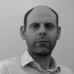 Picture of Jeremy Cohen in black and white wearing a striped shirt.
